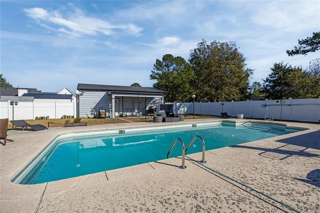 a view of a swimming pool with a lounge chairs