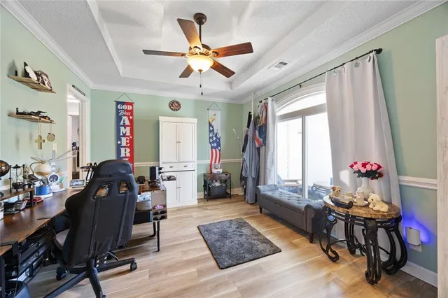 a workspace with wooden floor and windows