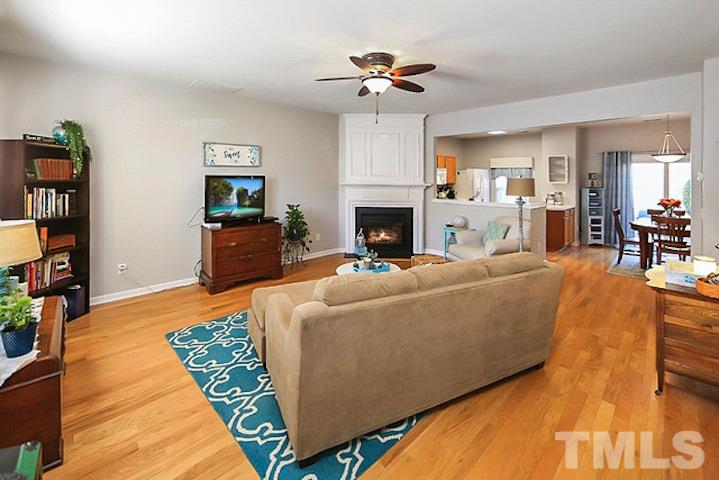 5013 Echo Ridge Road Raleigh, NC 27612 - Photo 2 of 15 a living room with furniture a fireplace and a flat screen tv