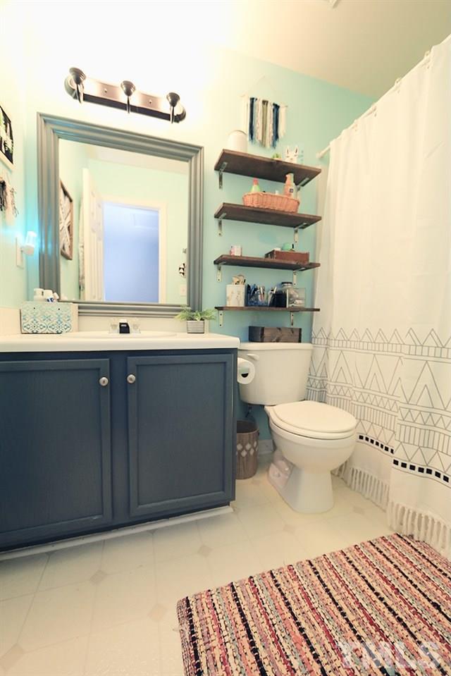 5013 Echo Ridge Road Raleigh, NC 27612 - Photo 12 of 15 a bathroom with a toilet sink and mirror