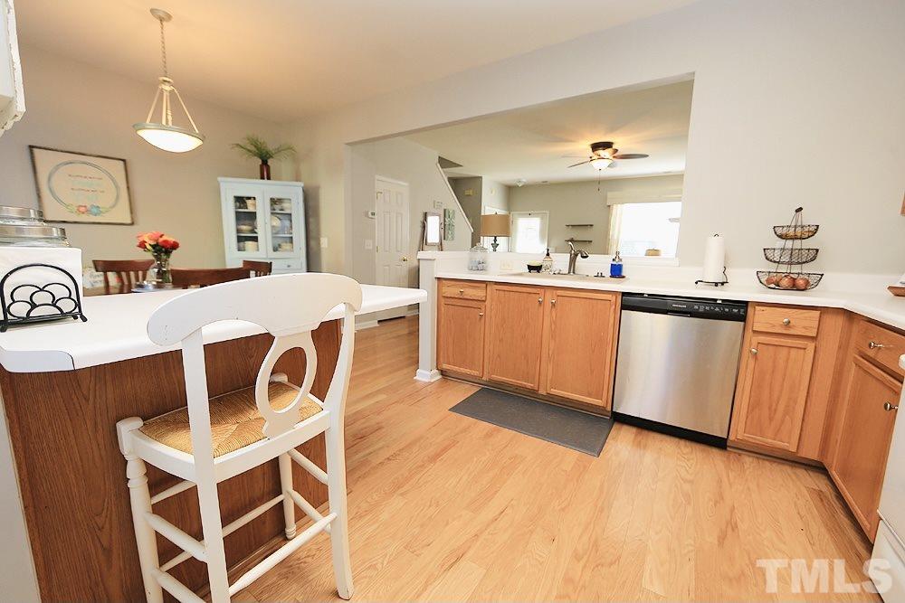 5013 Echo Ridge Road Raleigh, NC 27612 - Photo 6 of 15 a kitchen with stainless steel appliances a stove a sink dishwasher and a refrigerator