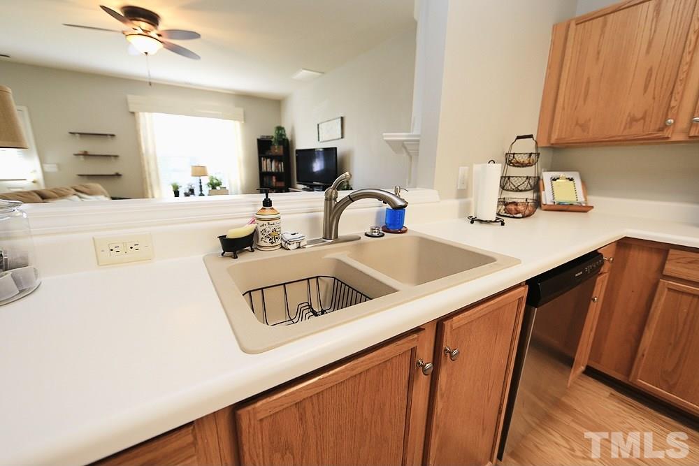 5013 Echo Ridge Road Raleigh, NC 27612 - Photo 7 of 15 a kitchen with a sink dishwasher and a refrigerator
