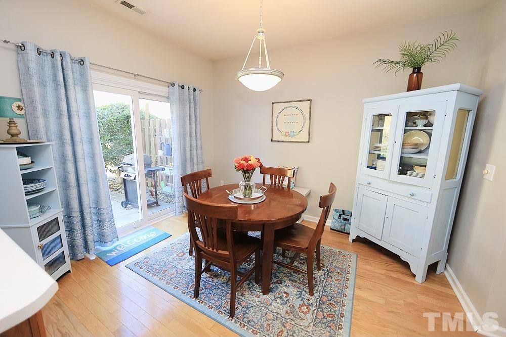 5013 Echo Ridge Road Raleigh, NC 27612 - Photo 8 of 15 a view of a dining room with furniture window and wooden floor