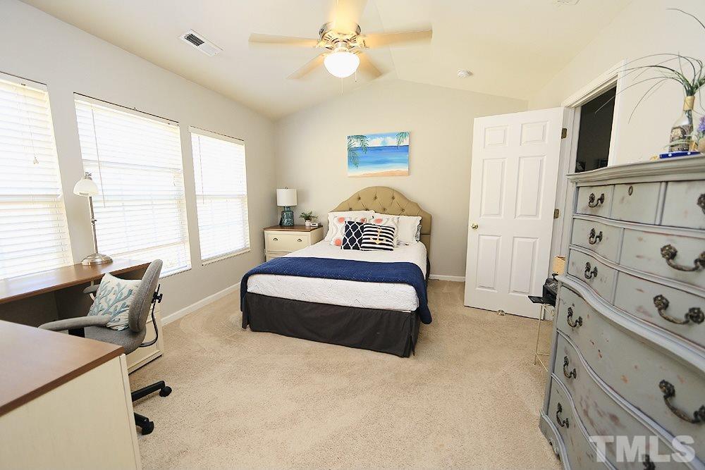 5013 Echo Ridge Road Raleigh, NC 27612 - Photo 9 of 15 a spacious bedroom with a bed and window