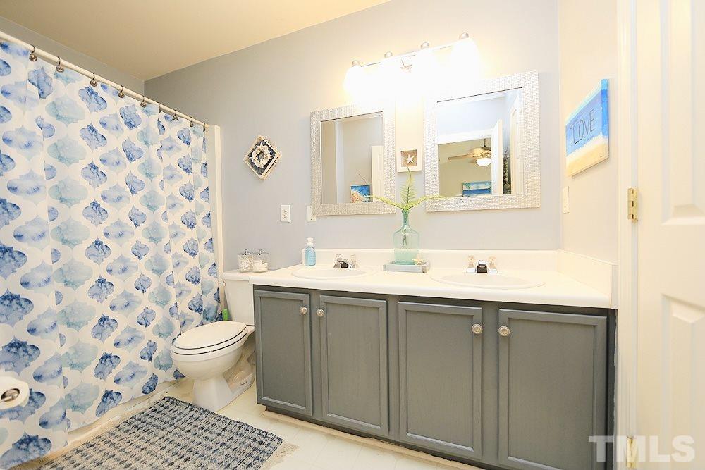 5013 Echo Ridge Road Raleigh, NC 27612 - Photo 10 of 15 a bathroom with a sink toilet and shower