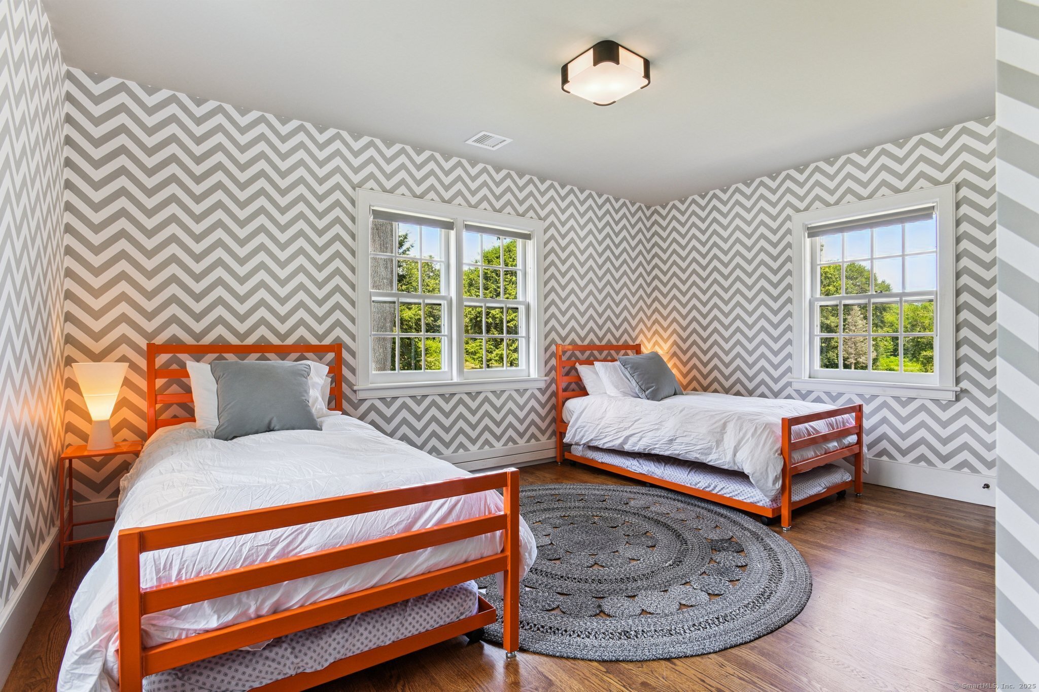 455 Stonington Road Stonington, CT 06378 - Photo 22 of 39 a bedroom with a bed and wooden floor