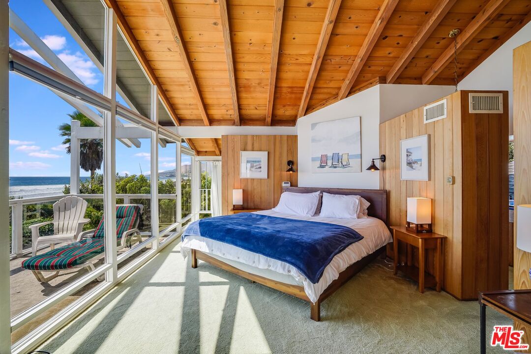 30800 Broad Beach Road Malibu, CA 90265 - Photo 15 of 27 a spacious bedroom with a large bed and a large window