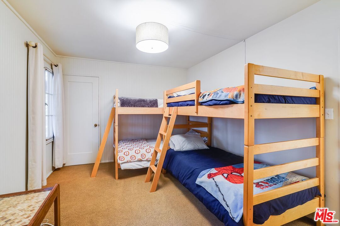 30800 Broad Beach Road Malibu, CA 90265 - Photo 24 of 27 a bedroom with a bunk bed and a chair