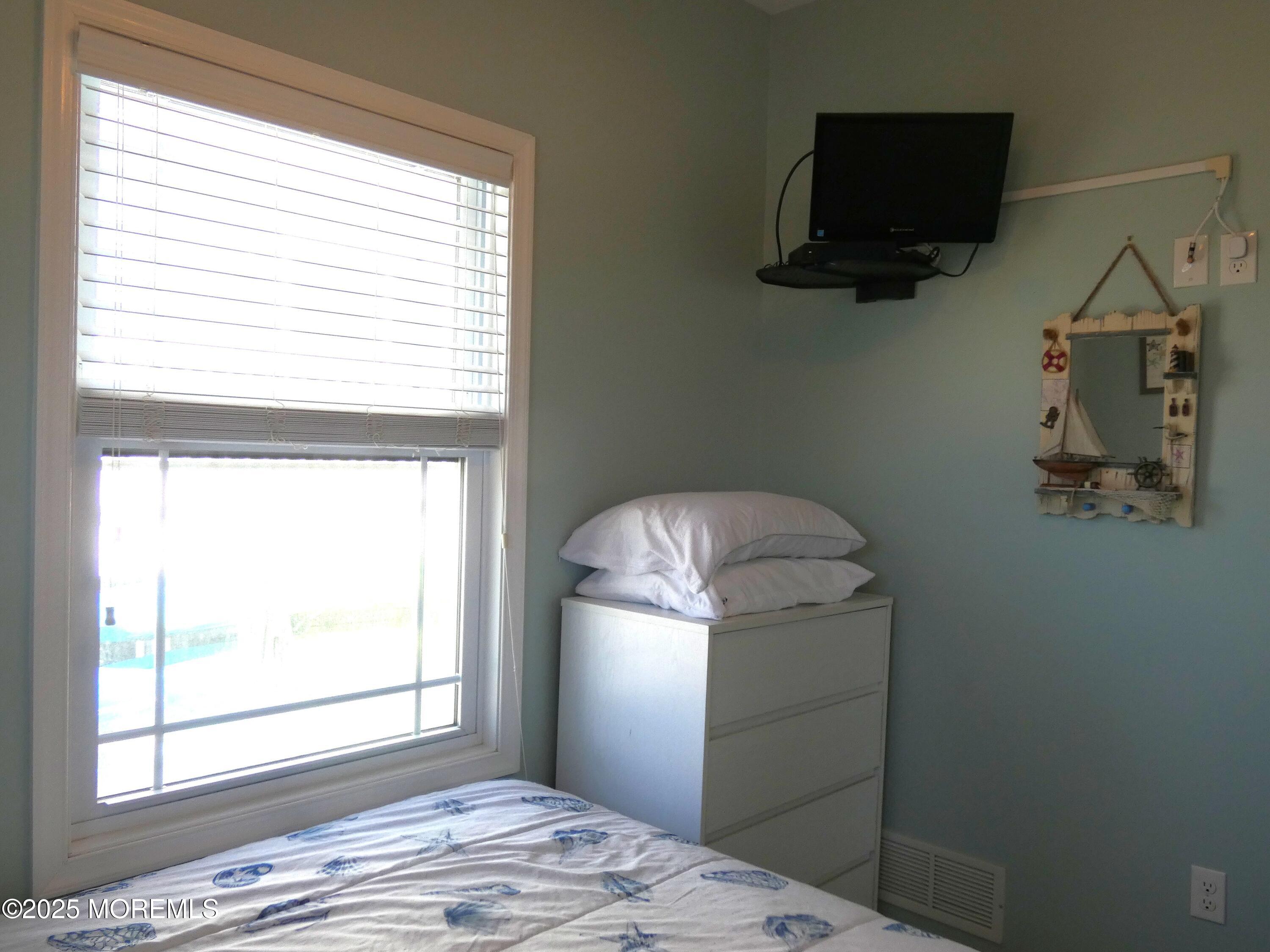 3311 Seaview Road Lavallette, NJ 08735 - Photo 14 of 27 a bedroom with a bed and a window