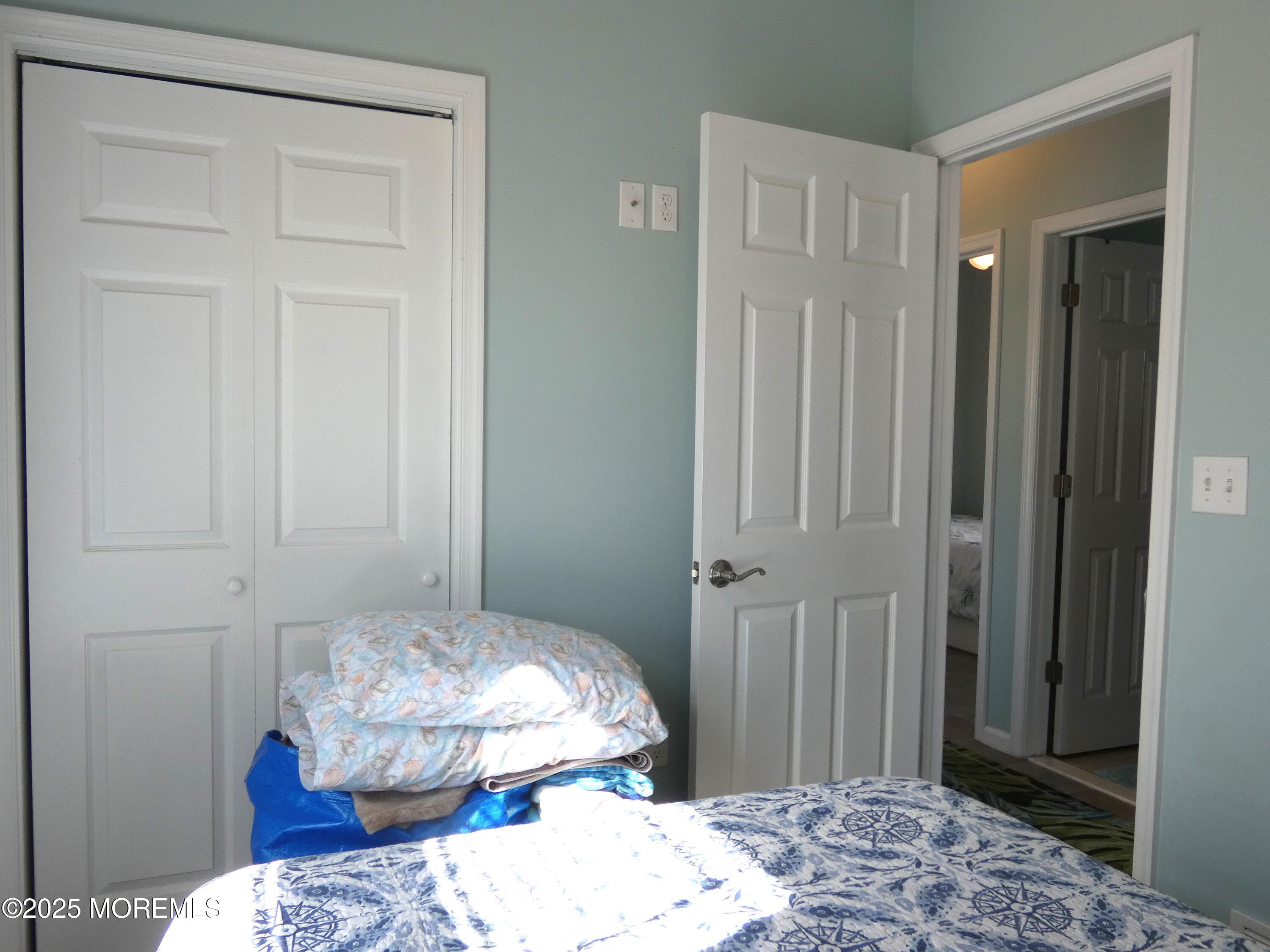 3311 Seaview Road Lavallette, NJ 08735 - Photo 17 of 27 a bedroom with a bed and a wooden floor