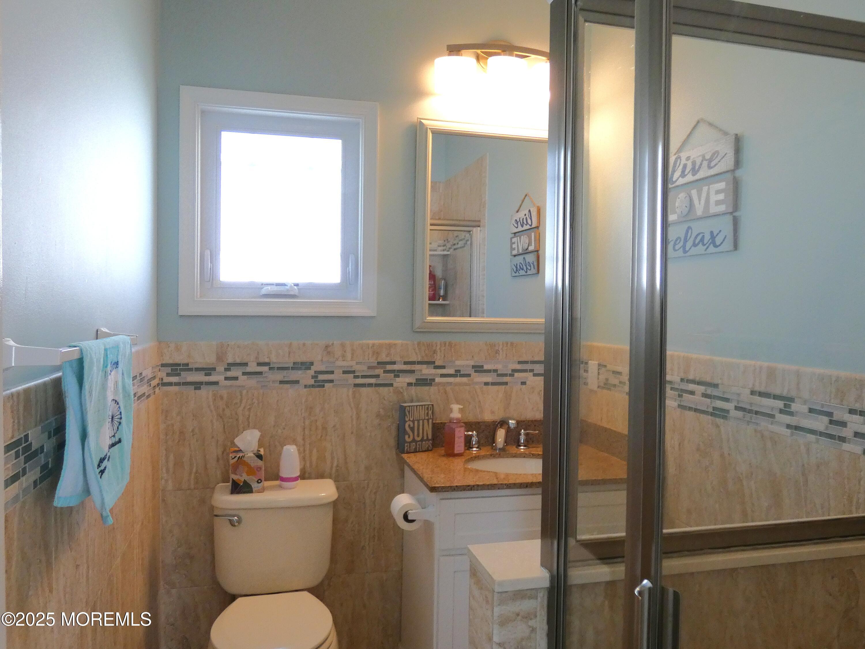 3311 Seaview Road Lavallette, NJ 08735 - Photo 18 of 27 a bathroom with a toilet a sink and mirror