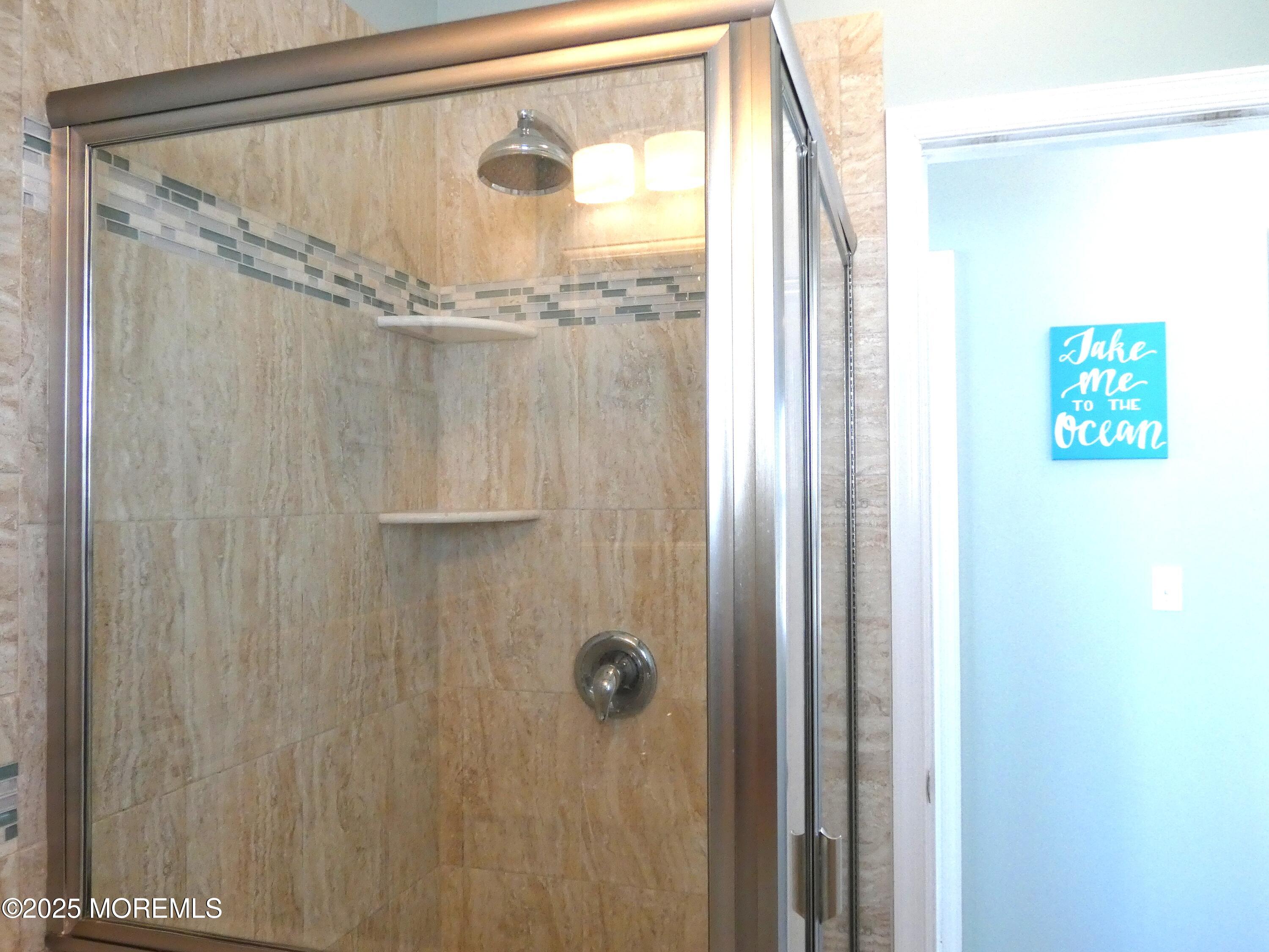 3311 Seaview Road Lavallette, NJ 08735 - Photo 19 of 27 a bathroom with a glass shower door
