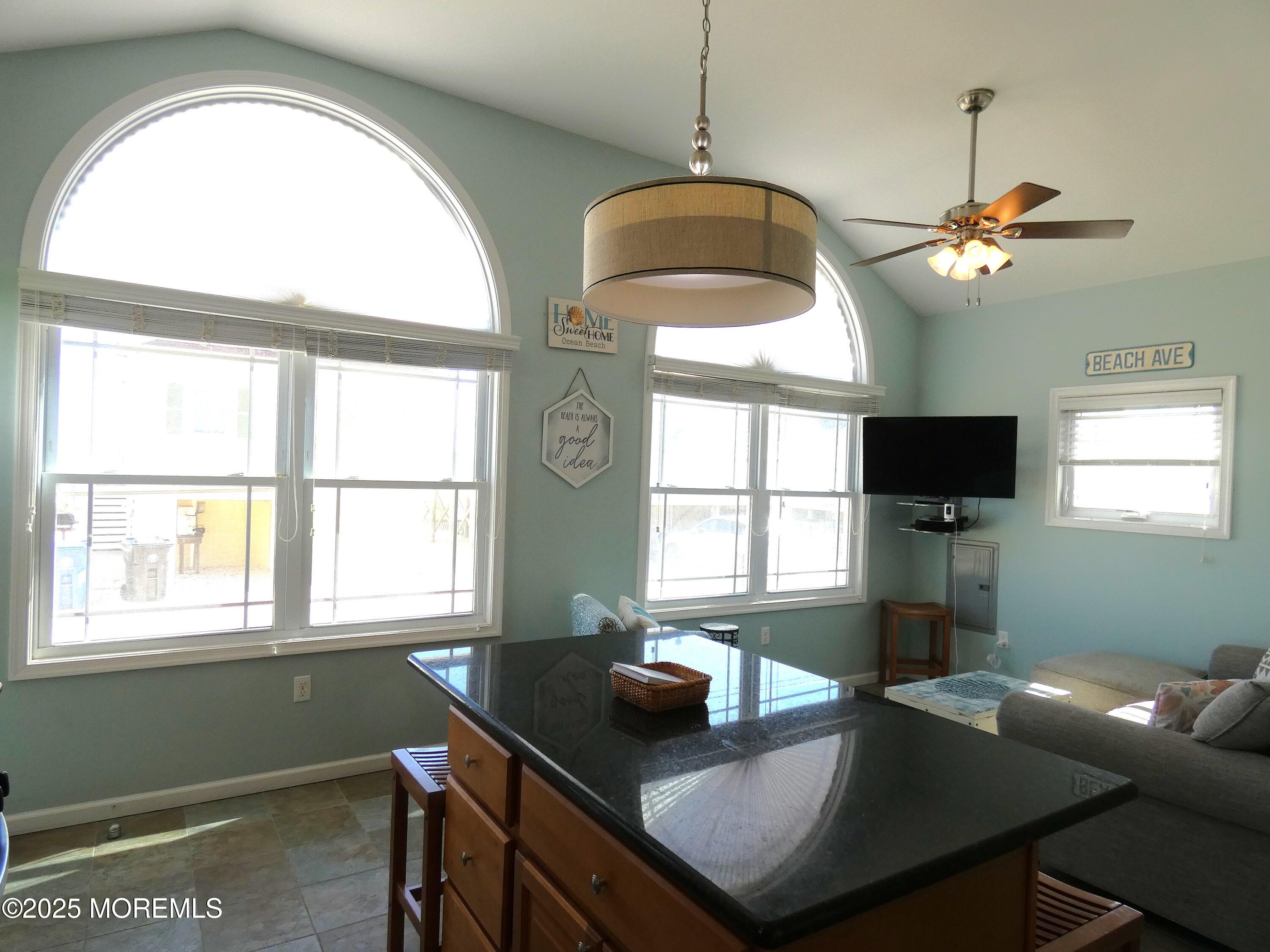 3311 Seaview Road Lavallette, NJ 08735 - Photo 4 of 27 a dining room with wooden floor a chandelier a wooden table and chairs