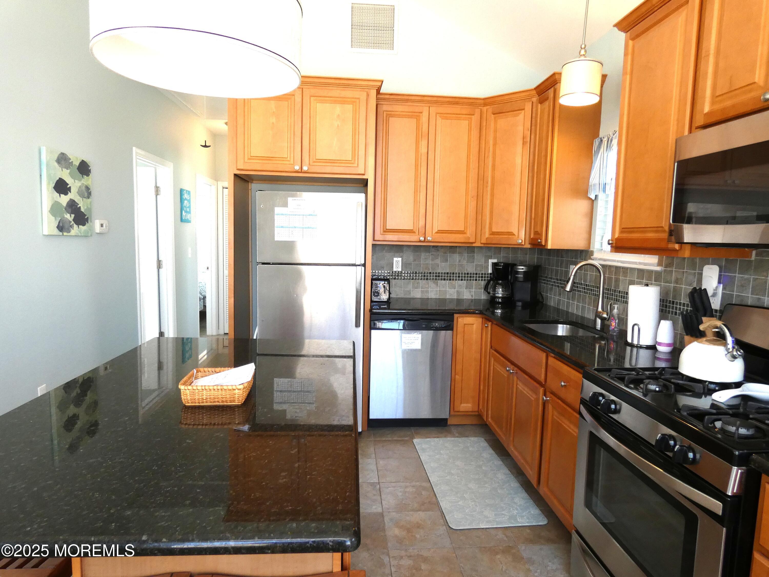 3311 Seaview Road Lavallette, NJ 08735 - Photo 7 of 27 a kitchen with stainless steel appliances a stove refrigerator sink and cabinets