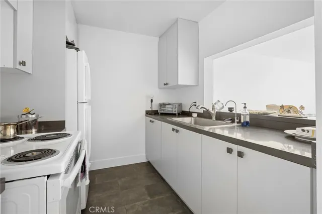 a kitchen with a stove a refrigerator and a sink