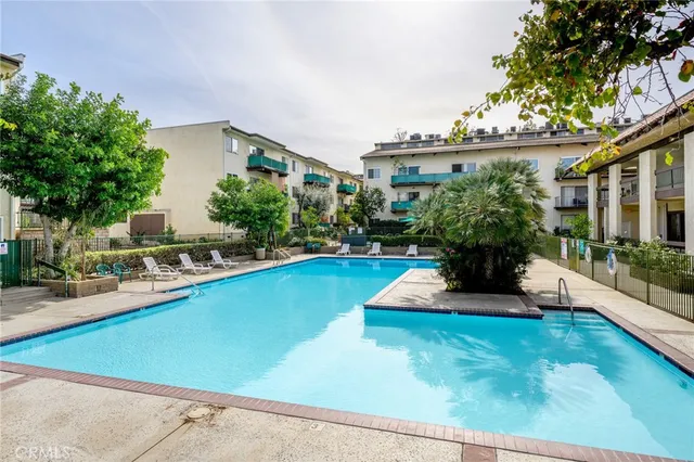 a view of a house with swimming pool and sitting area