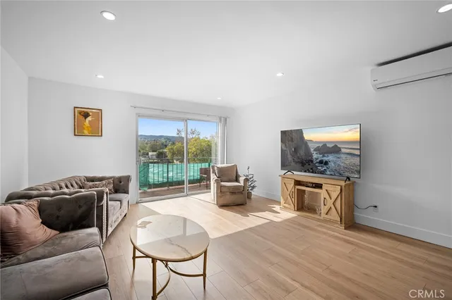 a balcony with furniture and wooden floor
