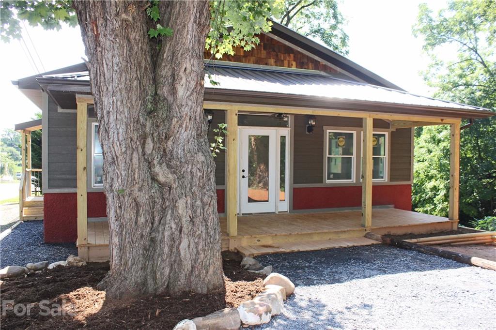 6722 Old Clyde Road Canton, NC 28716 - Photo 2 of 27 a view of a house with a tree in front of it