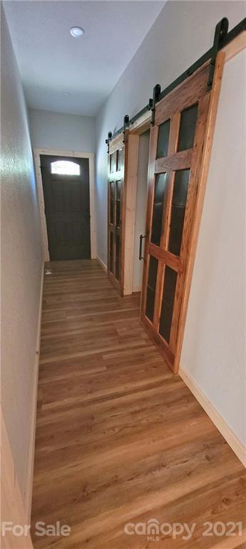 6722 Old Clyde Road Canton, NC 28716 - Photo 14 of 27 a view of a hallway with wooden floor and staircase