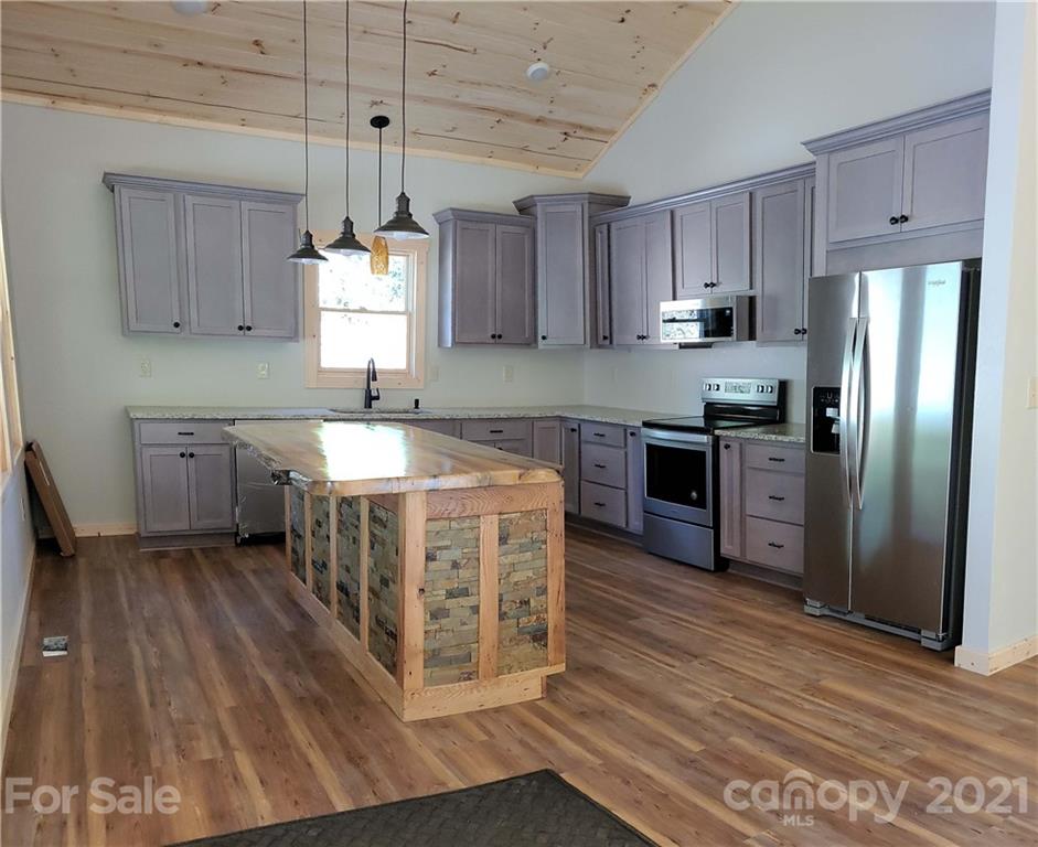 6722 Old Clyde Road Canton, NC 28716 - Photo 6 of 27 a kitchen with stainless steel appliances granite countertop a sink a stove and refrigerator