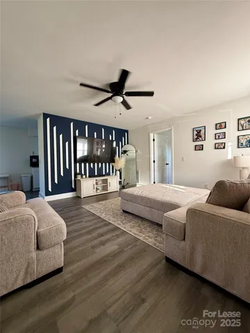 a spacious bedroom with a bed couch and a window