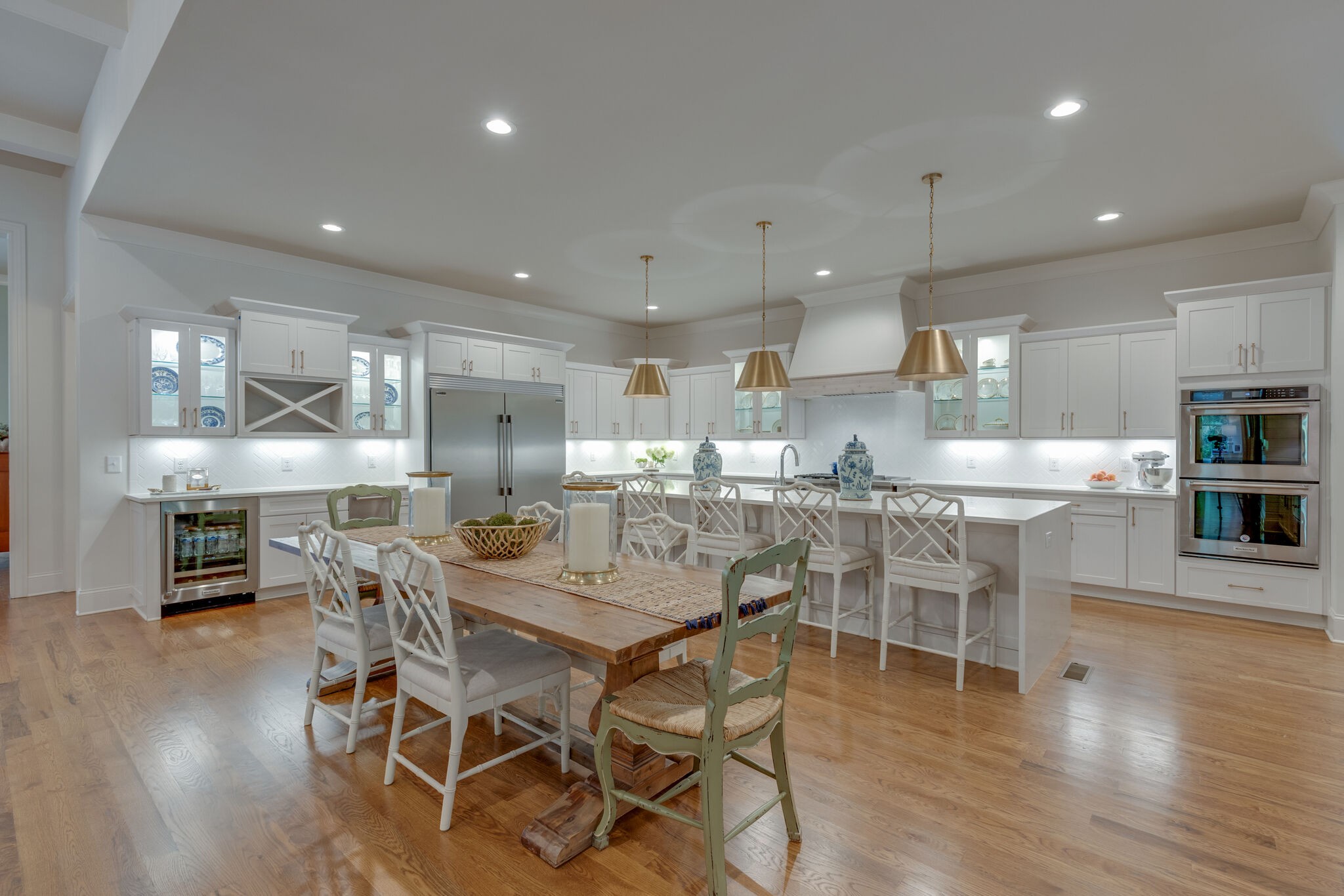 4841 Ollie Chunn Road Spring Hill, TN 37174 - Photo 13 of 69 a dining room with stainless steel appliances kitchen island granite countertop a table chairs and a refrigerator