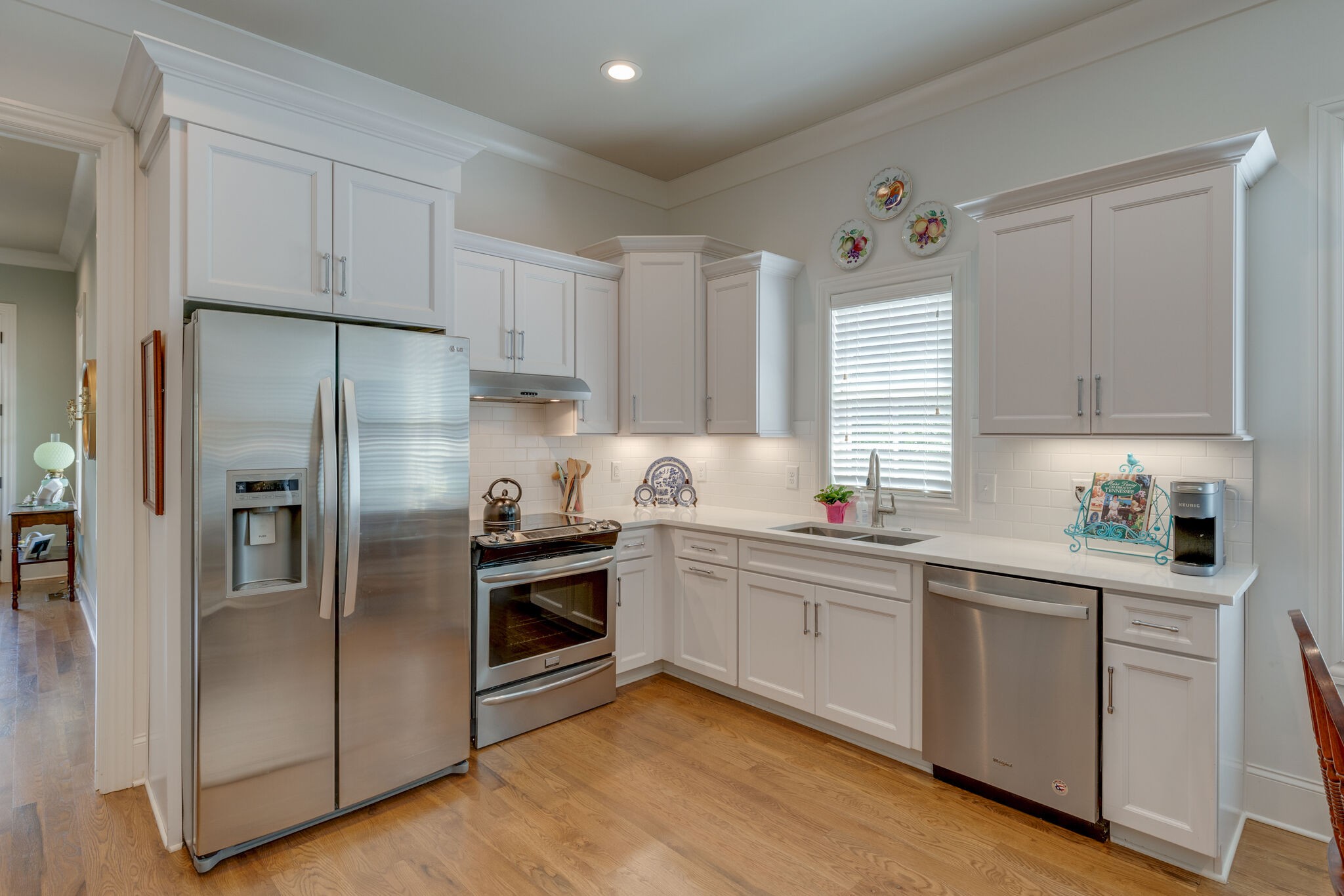 4841 Ollie Chunn Road Spring Hill, TN 37174 - Photo 34 of 69 a kitchen with white cabinets stainless steel appliances and a window