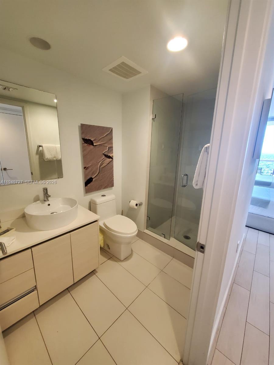 2602 East Hallandale Beach Boulevard, Unit R2810 Hallandale Beach, FL 33009 - Photo 18 of 31 a bathroom with a sink toilet and shower