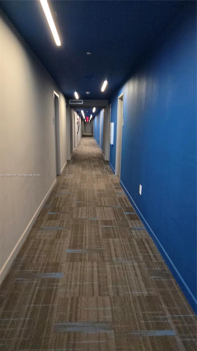 2602 East Hallandale Beach Boulevard, Unit R2810 Hallandale Beach, FL 33009 - Photo 27 of 31 a view of hallway with a projector