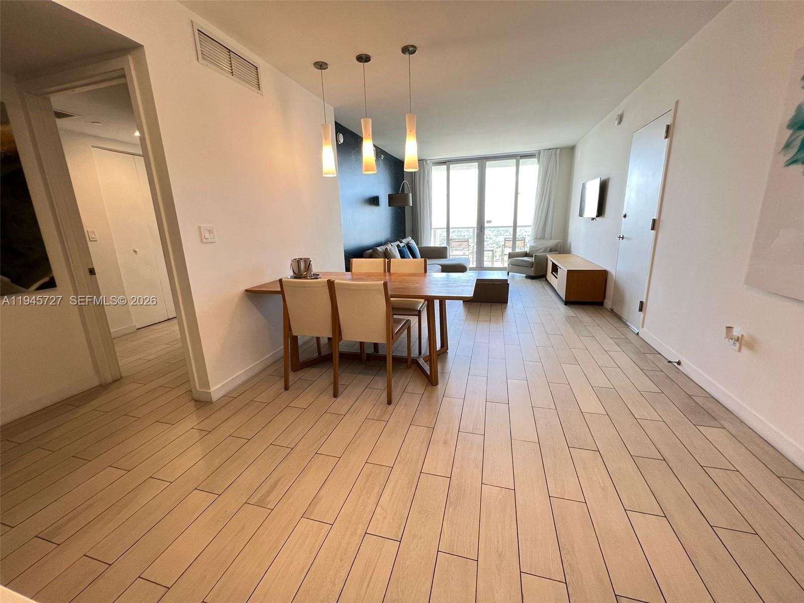 2602 East Hallandale Beach Boulevard, Unit R2810 Hallandale Beach, FL 33009 - Photo 6 of 31 a living room with furniture and a fireplace