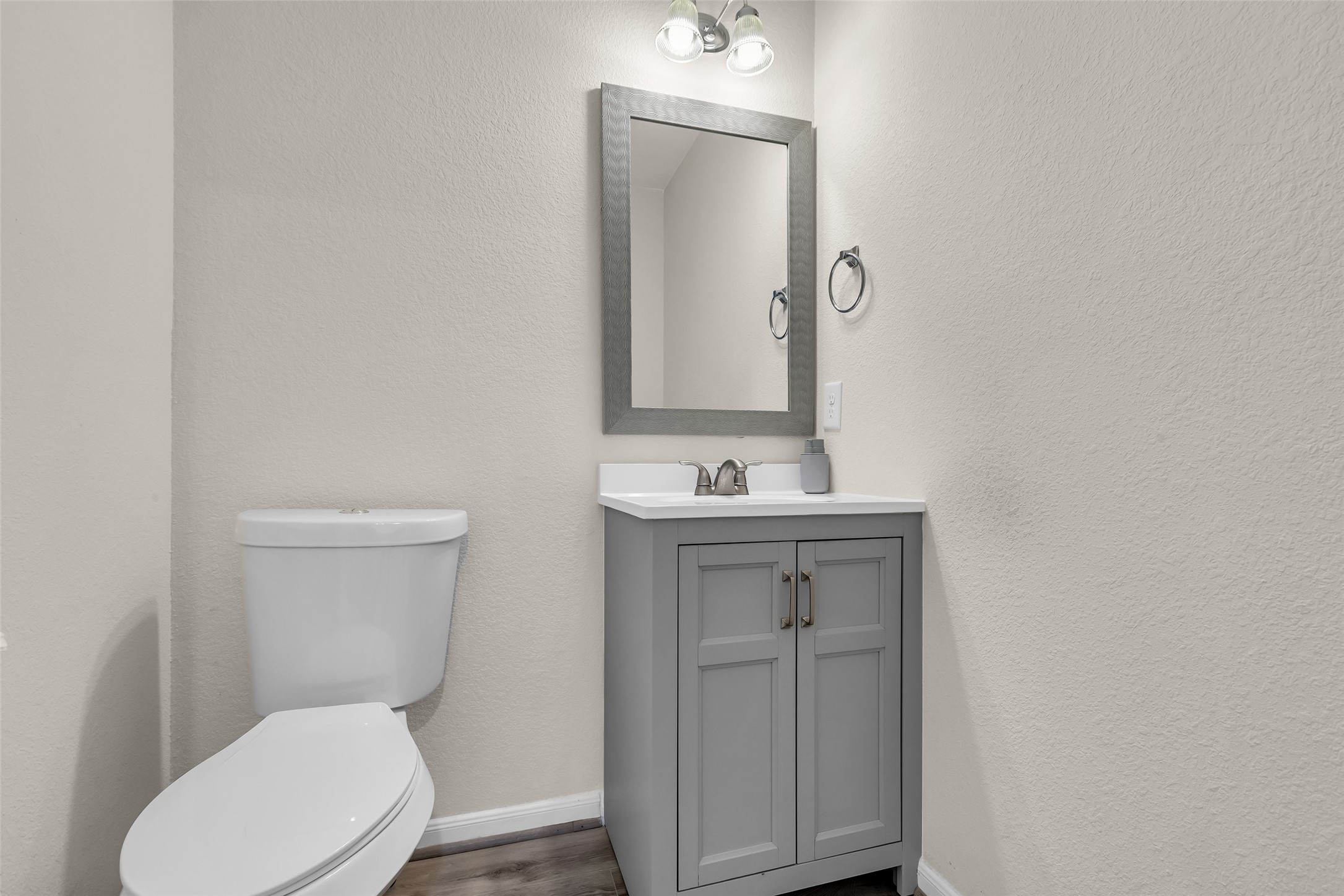 12626 Mint Field Houston, TX 77066 - Photo 14 of 26 a bathroom with a toilet a sink a vanity and mirror