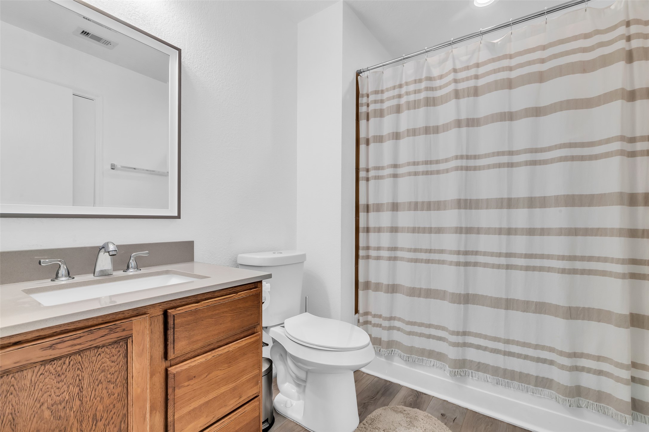 12626 Mint Field Houston, TX 77066 - Photo 16 of 26 a bathroom with a sink a toilet and shower curtain