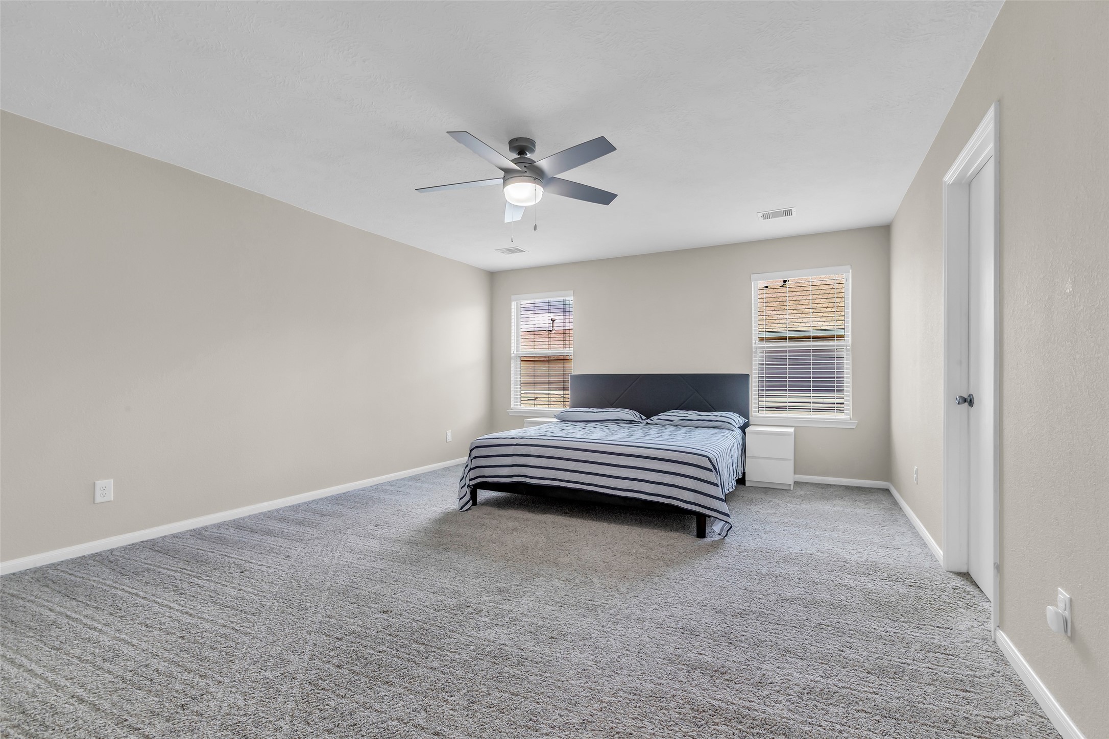 12626 Mint Field Houston, TX 77066 - Photo 19 of 26 a bedroom with a bed and a ceiling fan