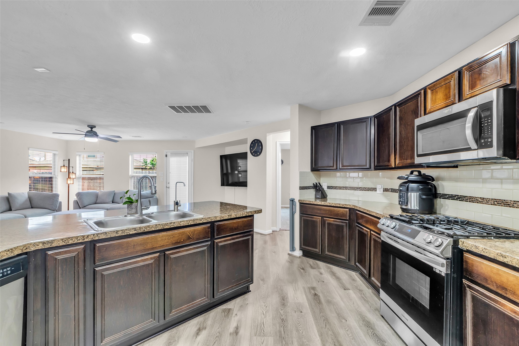 12626 Mint Field Houston, TX 77066 - Photo 4 of 26 a kitchen with stainless steel appliances granite countertop a sink stove and microwave