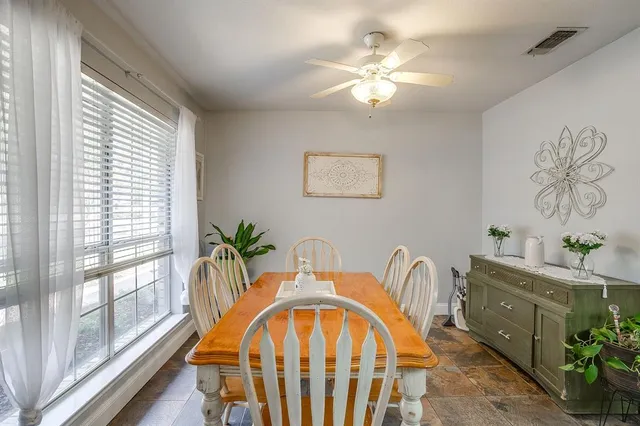 a view of a dining room with furniture and a chandelier