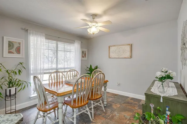 a dining room with furniture and window