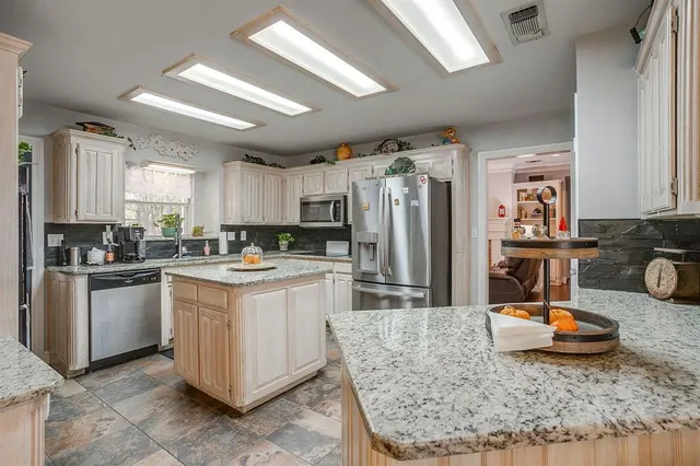 a kitchen with a refrigerator sink and stove