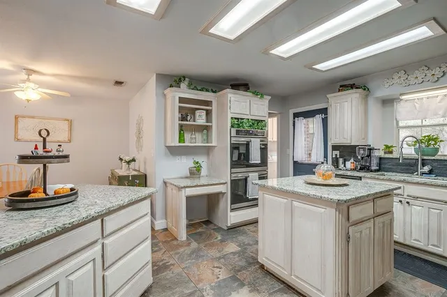 a kitchen with sink stove and cabinets
