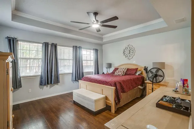 a spacious bedroom with a bed and a large window