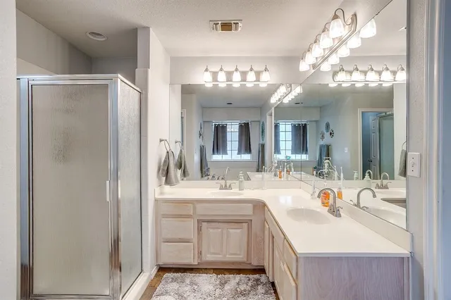 a bathroom with a sink double vanity and a mirror