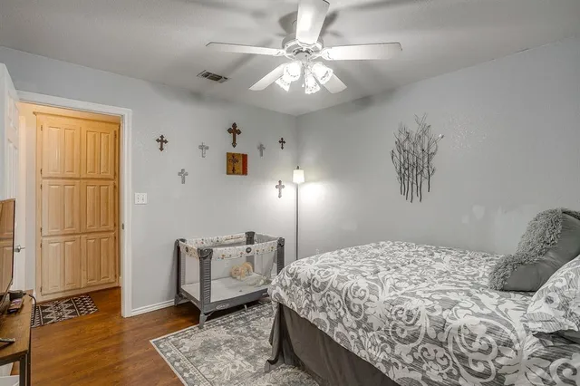 a bedroom with a large bed and a chandelier