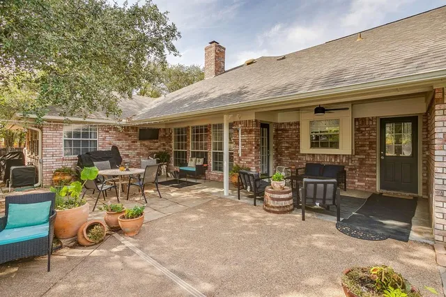 a view of a patio with table and chairs and potted plants