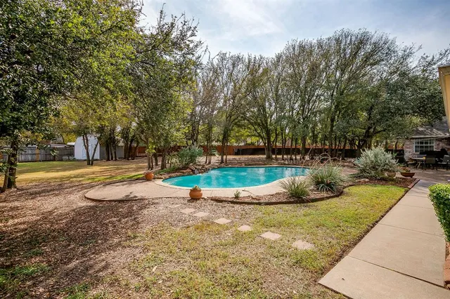 a view of a swimming pool with a patio