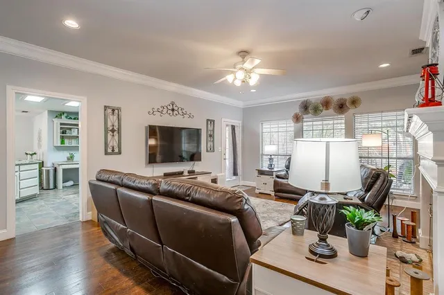 a living room with furniture a flat screen tv and a large window