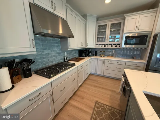 a kitchen with a sink a stove and cabinets