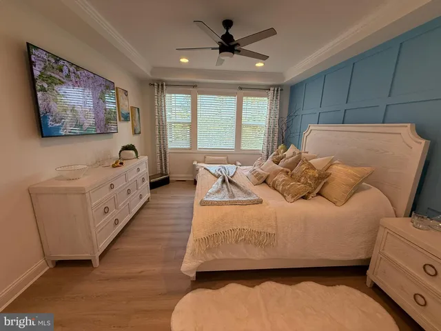 a bedroom with furniture and a large window