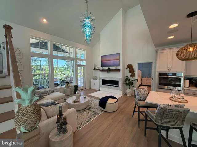 a work room with furniture a rug and a chandelier