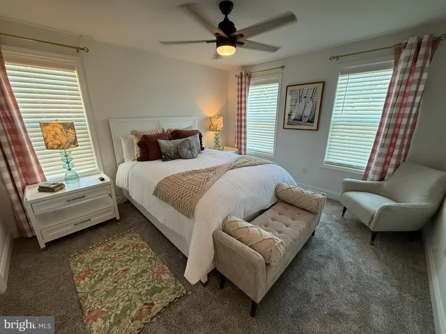 a bedroom with a bed a couch and a window