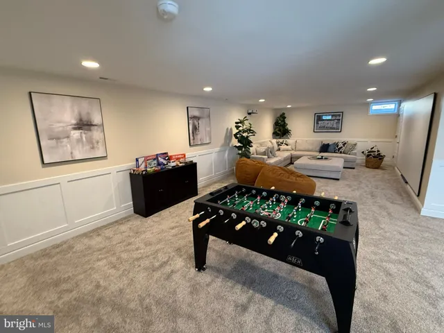 a living room with furniture and a dresser