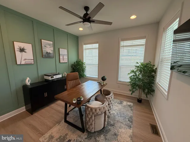 a living room with furniture and a potted plant